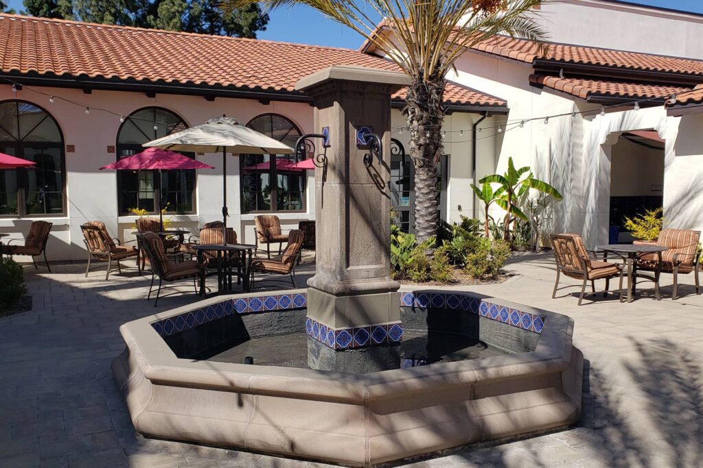 A fountain in the middle of an outdoor patio.