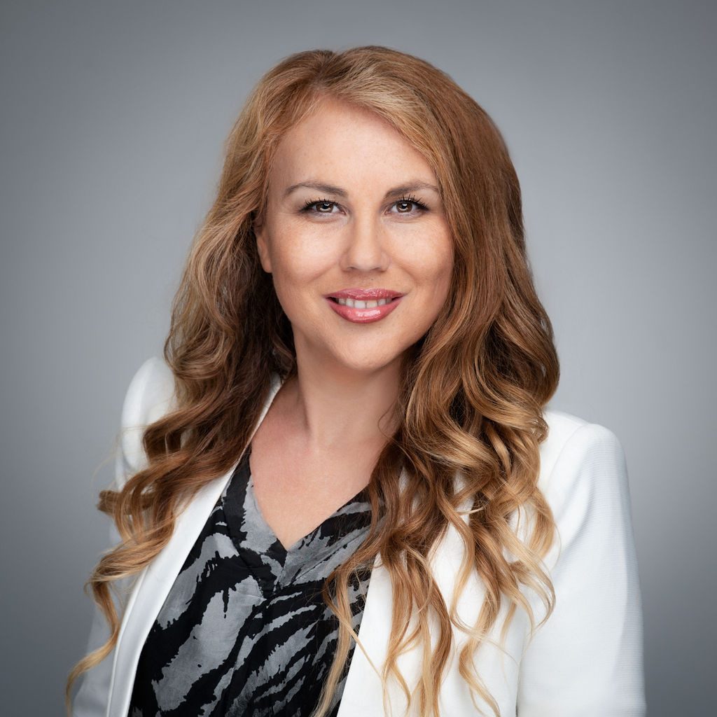 A woman with long hair and a white jacket.