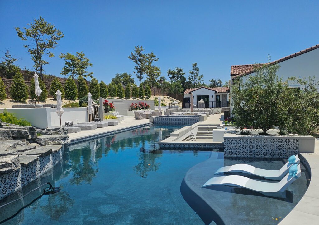 Luxury pool and patio with house.