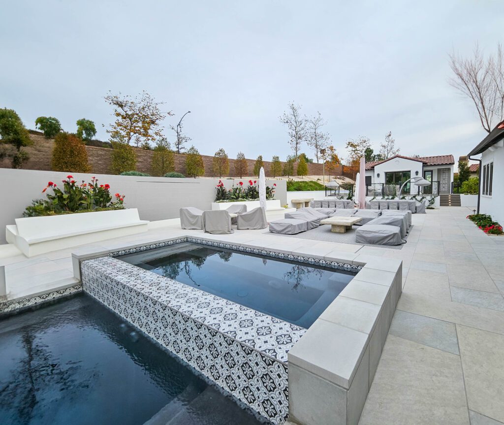 Modern backyard pool and patio furniture.