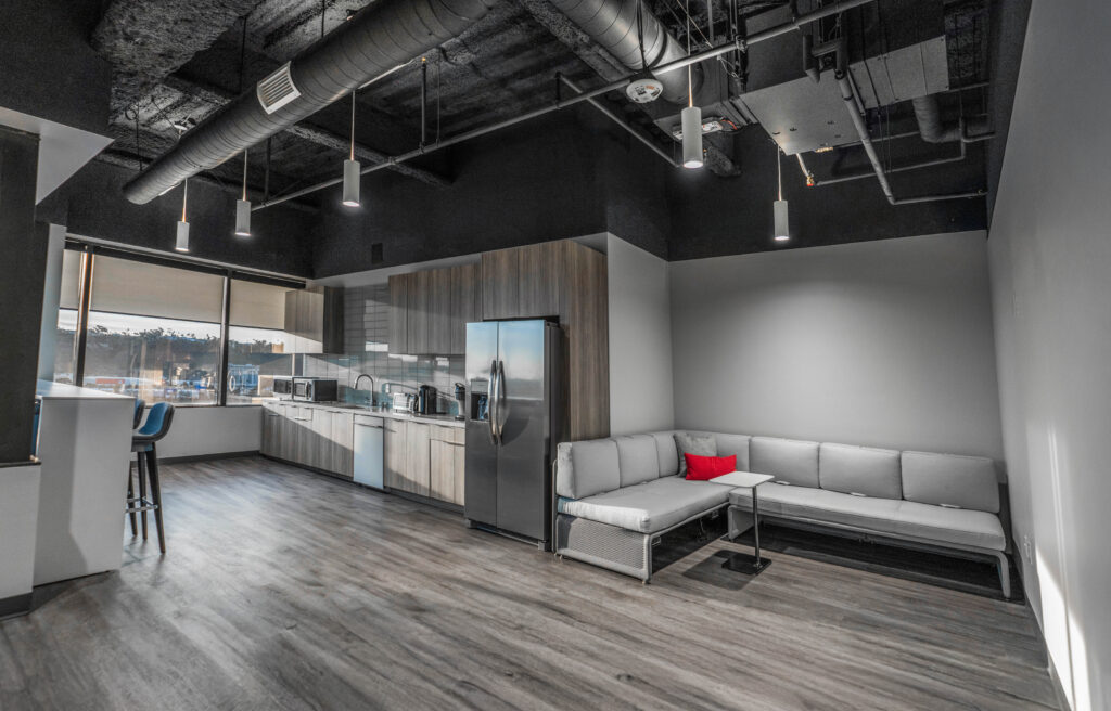 Modern office break room with seating.