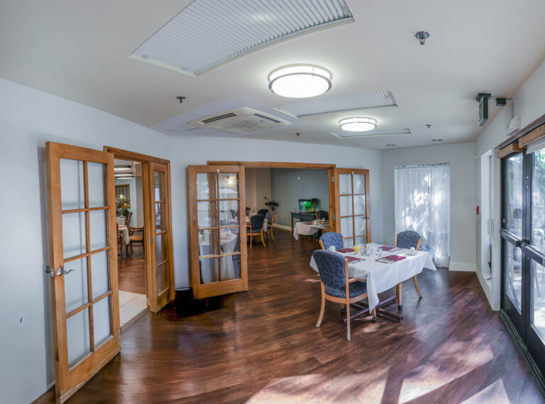 Dining room with hardwood floors and tables.
