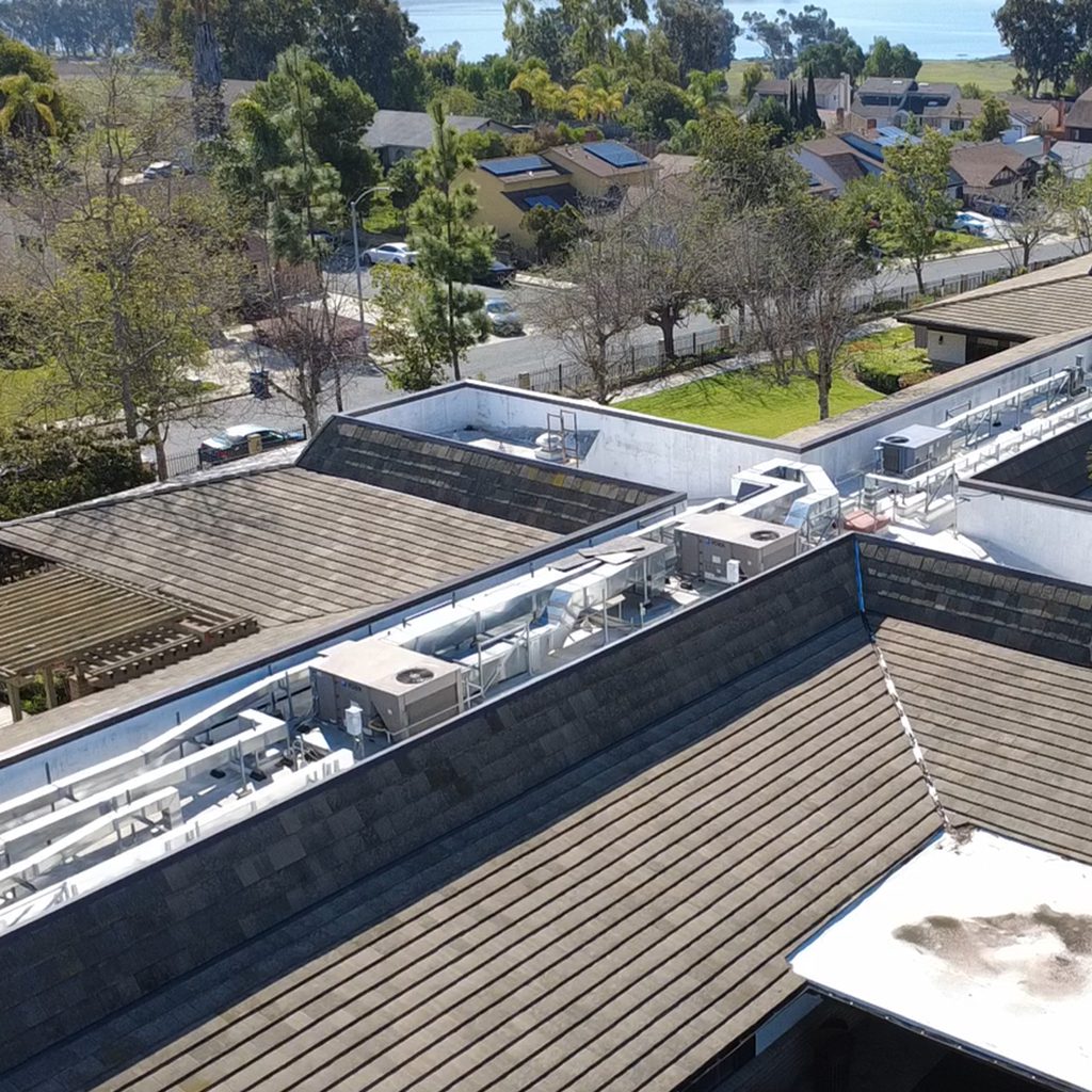 Aerial view of rooftops and trees.