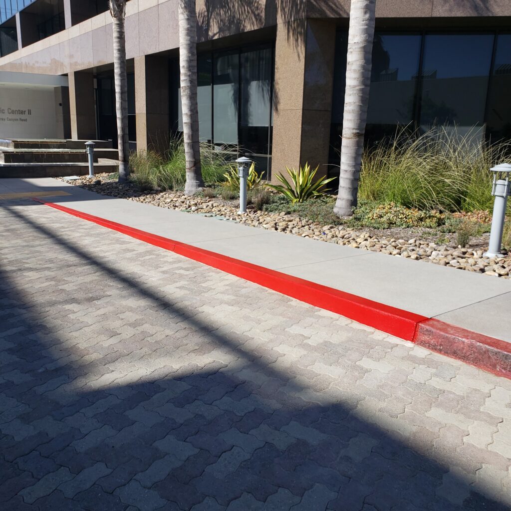 Building exterior with palm trees and walkway.