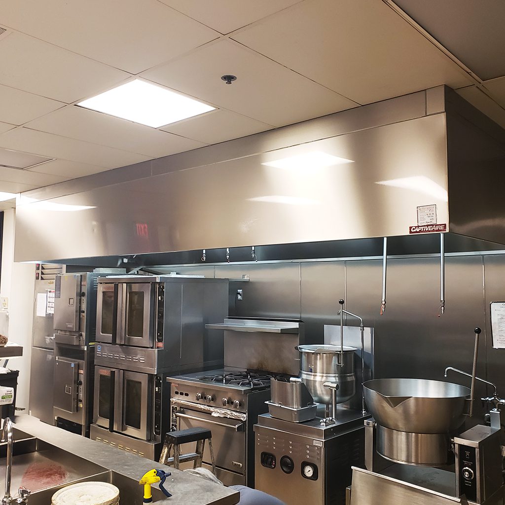 Commercial kitchen with stainless steel equipment.