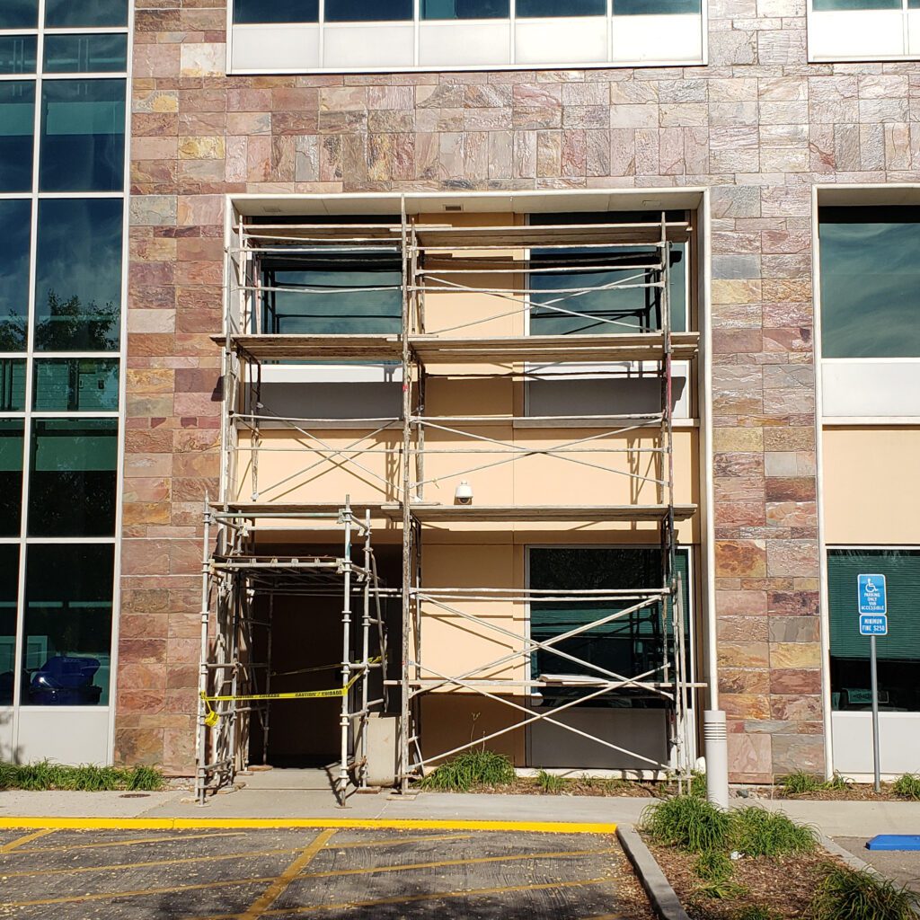 Building entrance with scaffolding under construction.