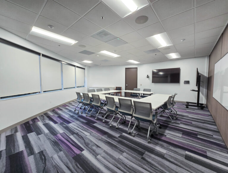 Modern conference room with arranged chairs and tables.