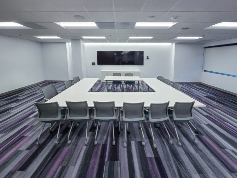 Modern conference room with U-shaped table setup.