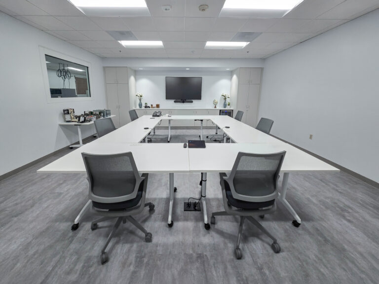 Modern conference room with white tables.