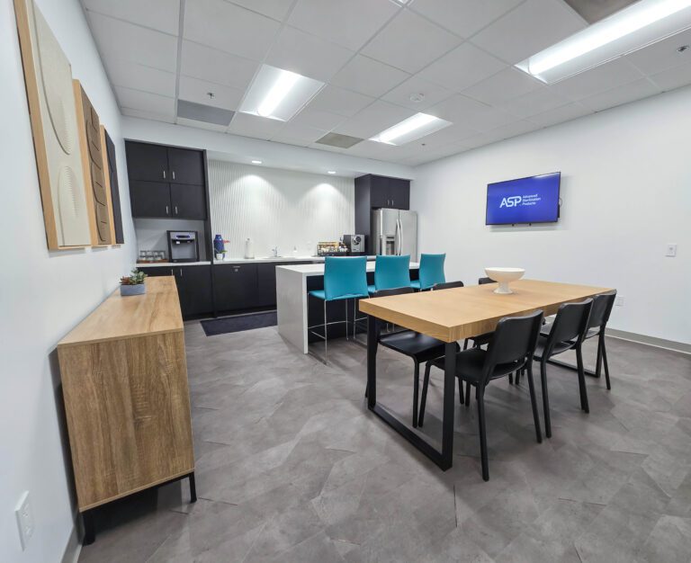 Modern office kitchen with dining area.