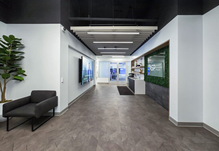 Modern office lobby with seating and signage.