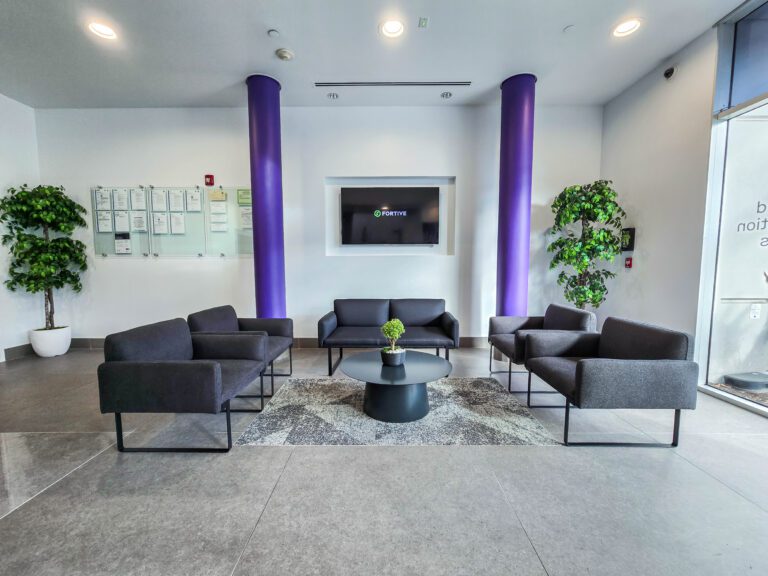 Modern office lobby with seating area.