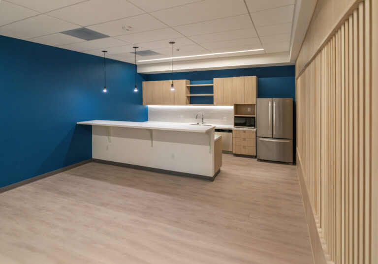 Modern kitchenette with island and blue wall