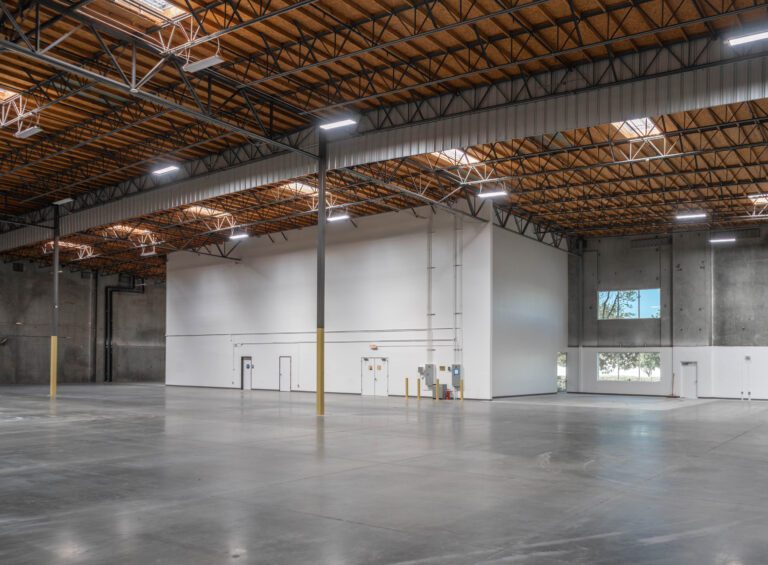 Spacious empty warehouse with interior office unit
