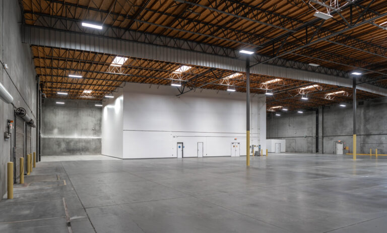 Empty industrial warehouse with interior office structure