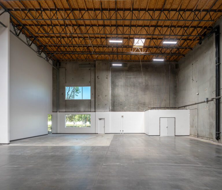 Empty modern warehouse with exposed wooden ceiling