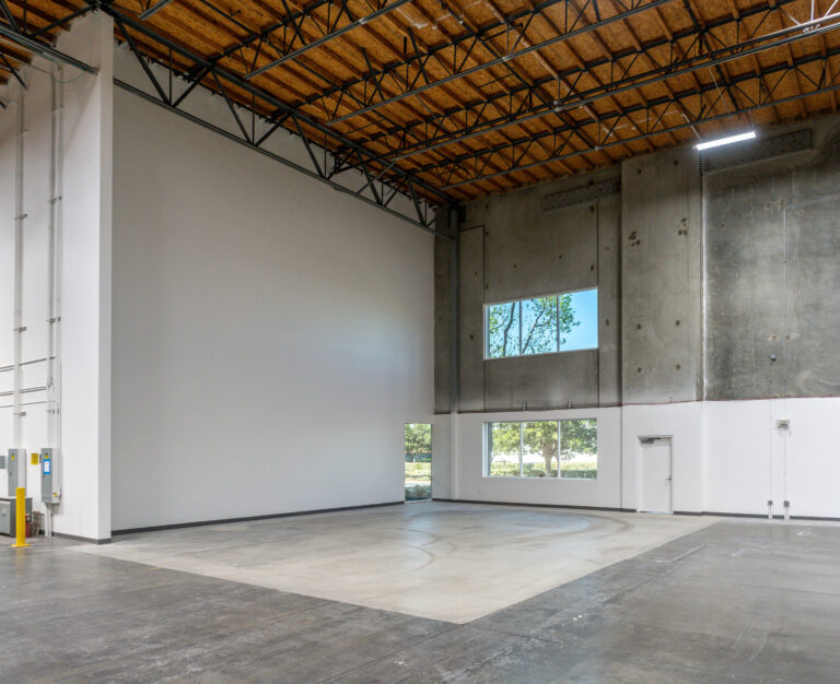 Empty industrial warehouse interior with high ceiling